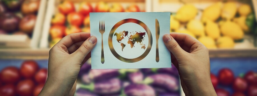 erradicação da pobreza: recorte de papel em formato de garfo, faca e prato em frente a legumes