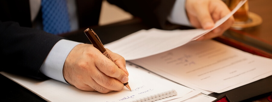 direito notarial e registral: homem assinando documentos