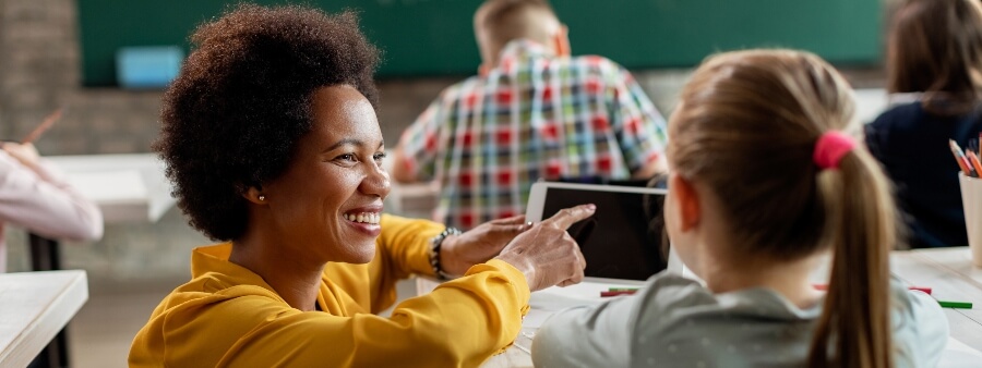CNU da educação: professora sorrindo para aluna